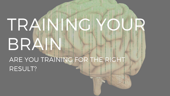 text "training your brain" over an illustration of a yellow brain on a black background