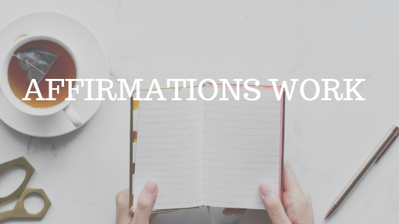 a flat lay photo of a woman's hands holding a journal beside a cup of coffee with white text reading "affirmations work"