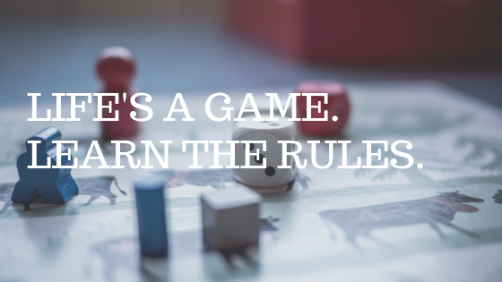 Game board with dice, with white text reading "life's a game, learn the rules" 