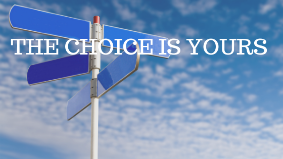 A blue sky with a multi-directional blank signpost in front of it and white text reading "the choice is yours"