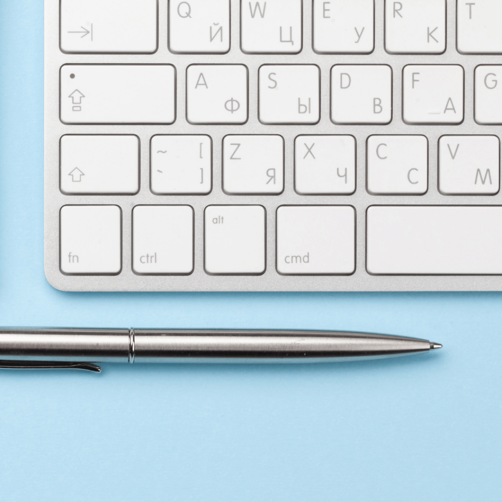 keyboard and pen on blue background